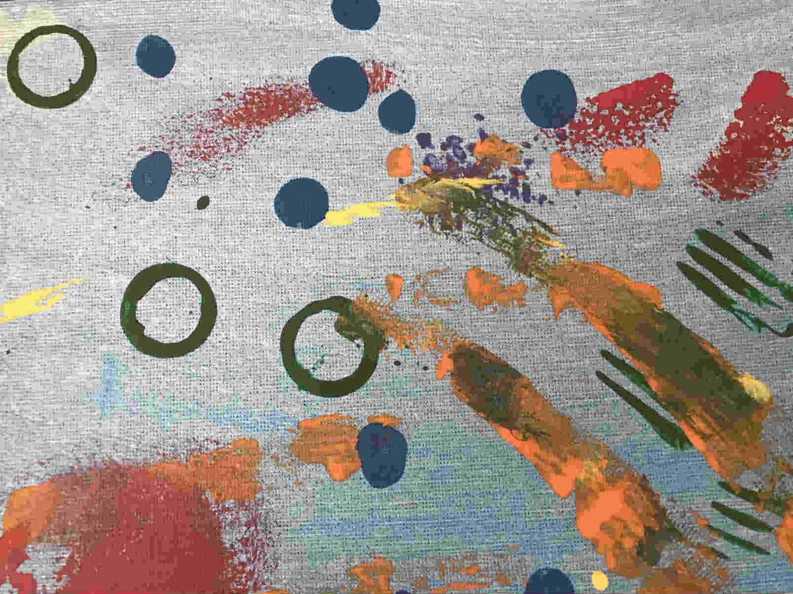 Abstract art, of blue background with circles of green and bits of other primary colors.